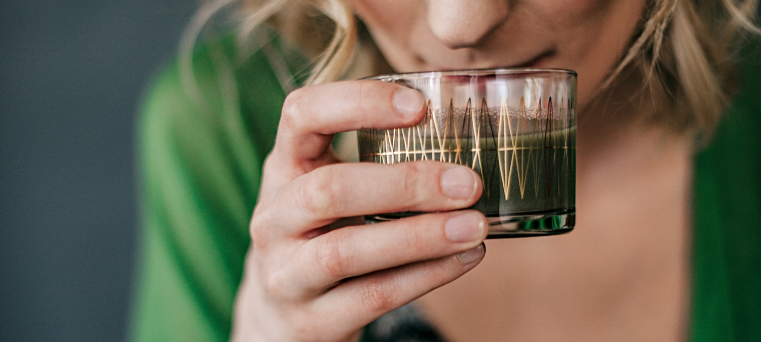 Woman drinking E3Live Superfood Liquid